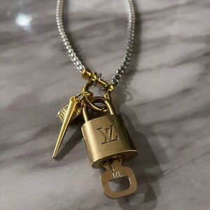 Louis Vuitton Gold Lock with Silver Chain necklace.